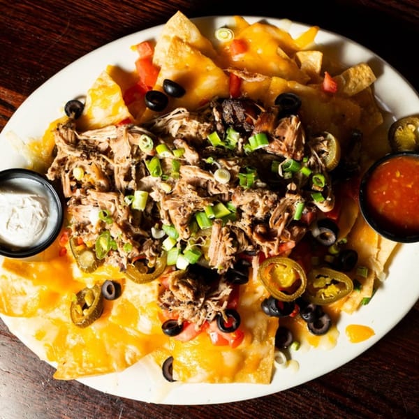 Half Moon Restaurant & Brewery's pulled pork nachos with cheese, jalapeños, olives, and green onions.