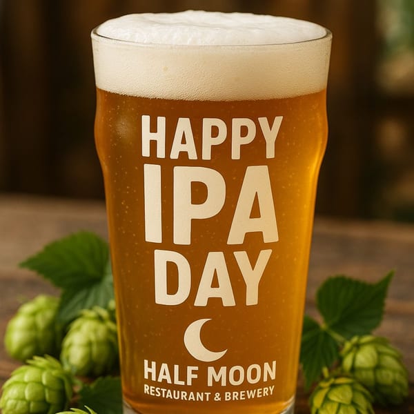 Half Moon Restaurant & Brewery IPA beer glass with "Happy IPA Day" text and hops.