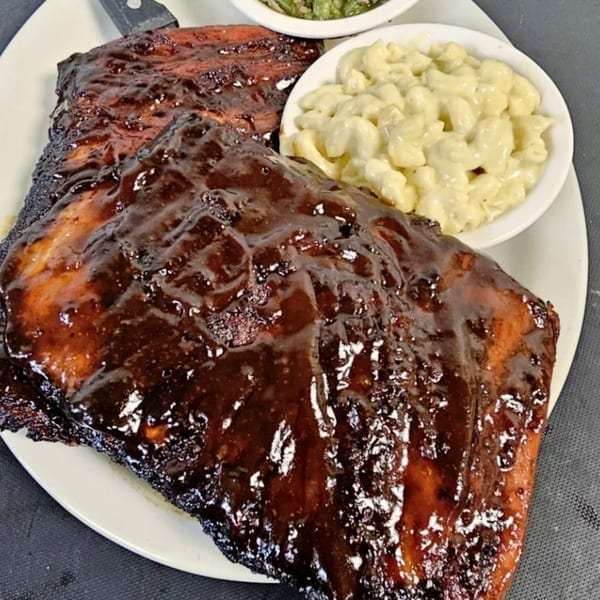 Half Moon Restaurant & Brewery's BBQ ribs with mac and cheese and green beans on a white plate.