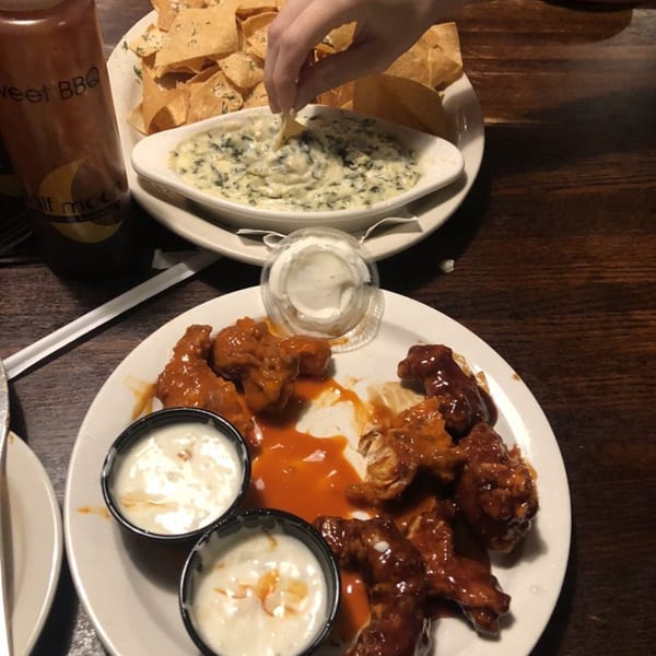 Half Moon Restaurant & Brewery's chicken wings with dipping sauces, spinach dip, and tortilla chips.