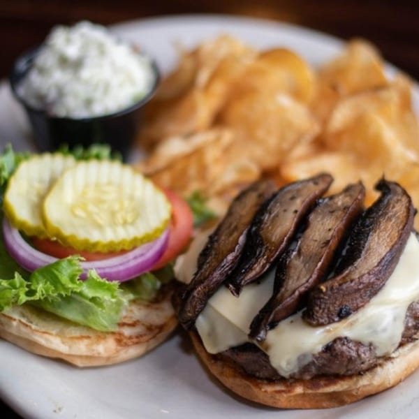 Half Moon Restaurant & Brewery's mushroom swiss burger with chips and a side of coleslaw.